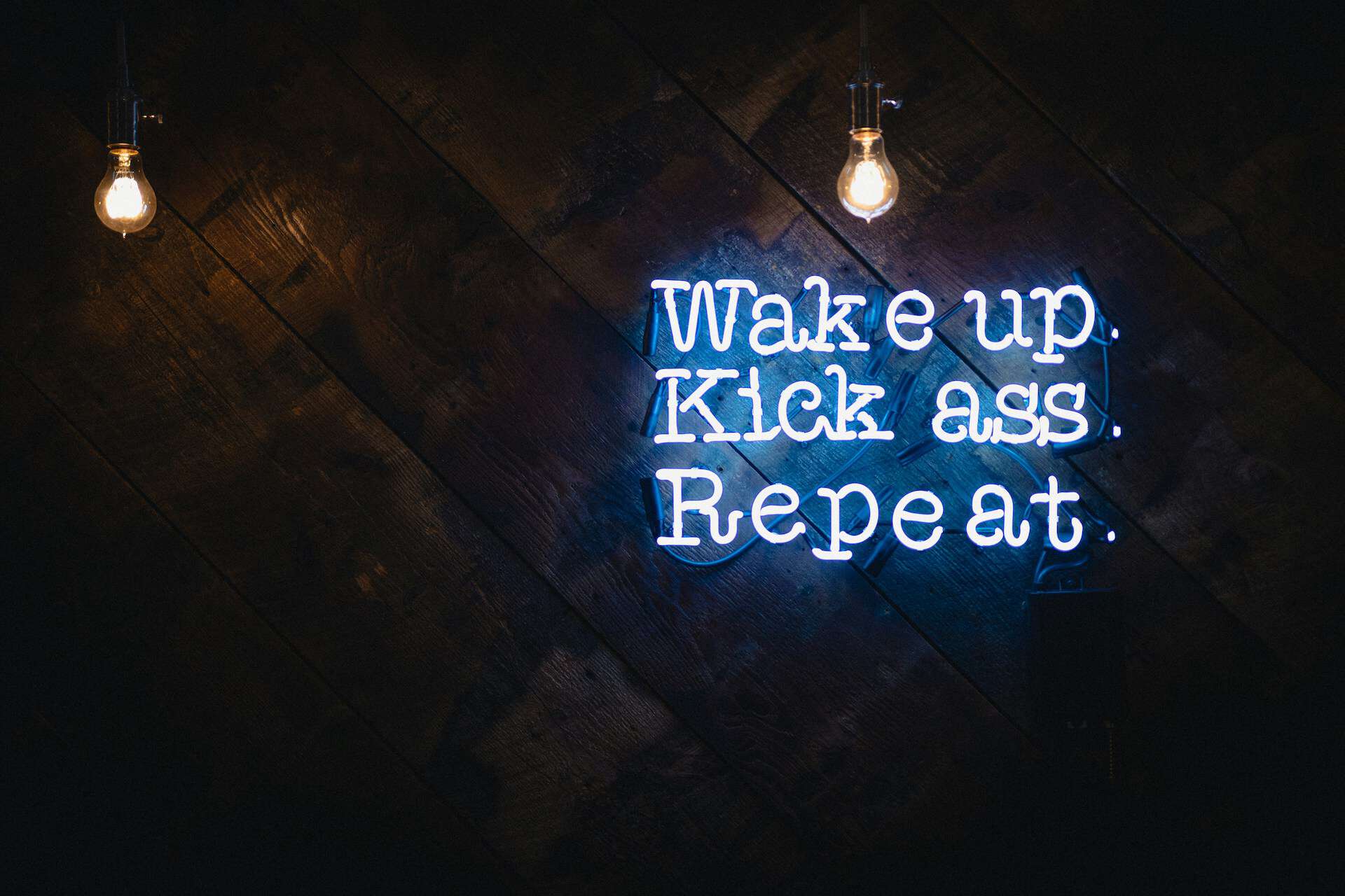 Neon sign "Wake up. Kick ass. Repeat." Kelowna website design Misfit Media web design hosting and SEO in Kelowna, BC